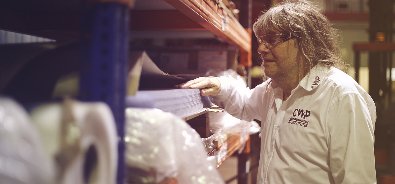 man inspecting material in a workshop